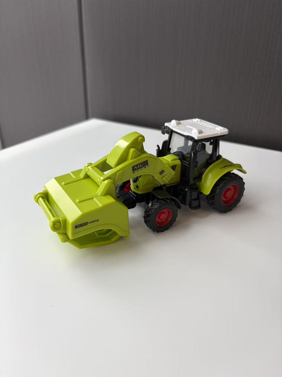 Green Compact Loader Backhoe Model with Front Bucket and Rear Arm