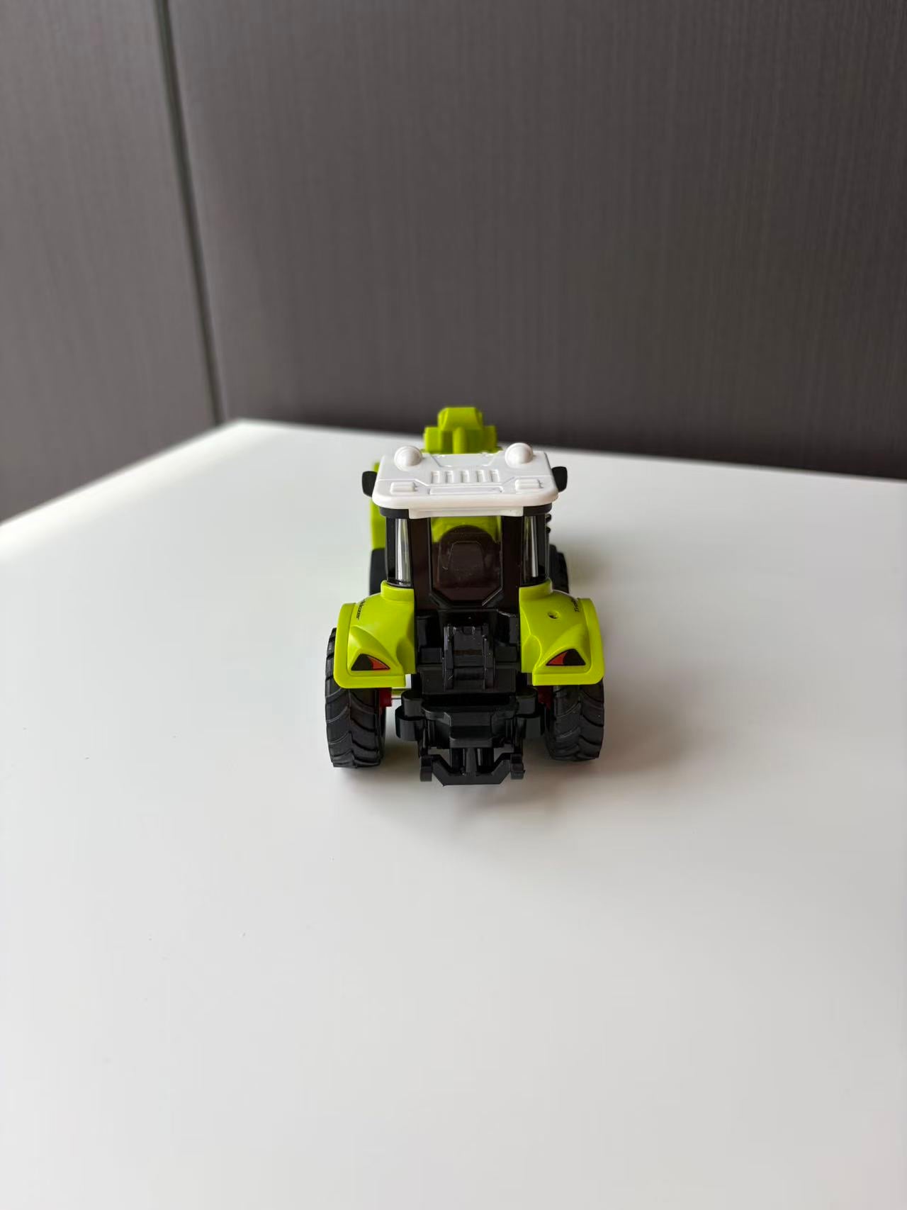 Green Compact Loader Backhoe Model with Front Bucket and Rear Arm