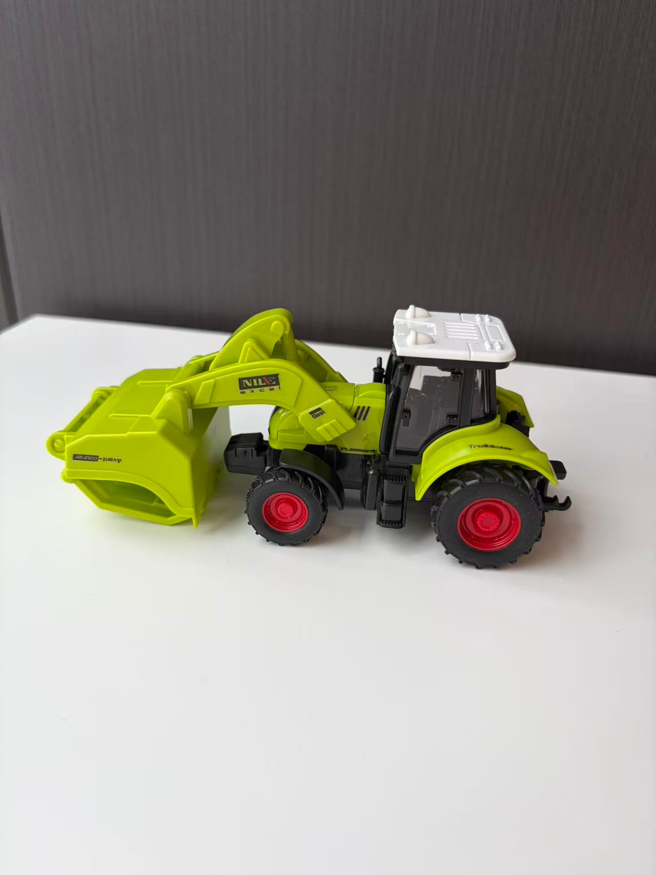 Green Compact Loader Backhoe Model with Front Bucket and Rear Arm