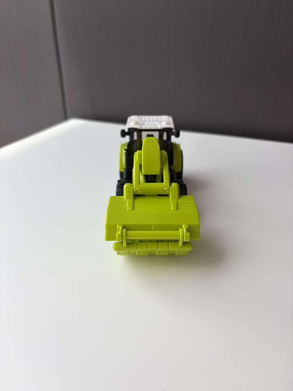 Green Compact Loader Backhoe Model with Front Bucket and Rear Arm